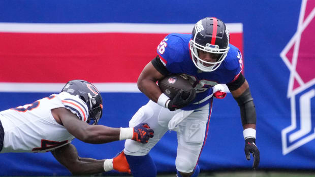 Saquon Barkley tries to break away against the Bears in a game in New Jersey. Could he becoming to Chicago to play?